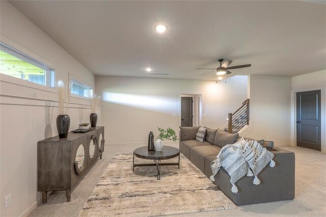 living room featuring ceiling fan and light colored carpet