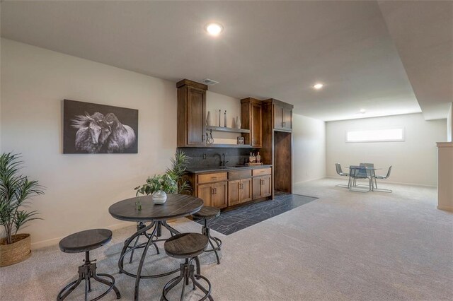 kitchen with sink and dark colored carpet