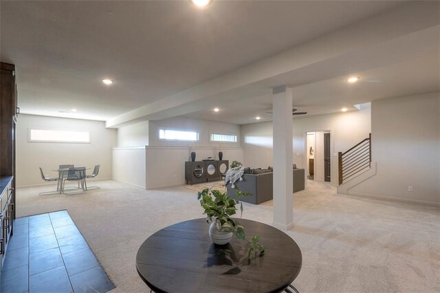 basement featuring light carpet