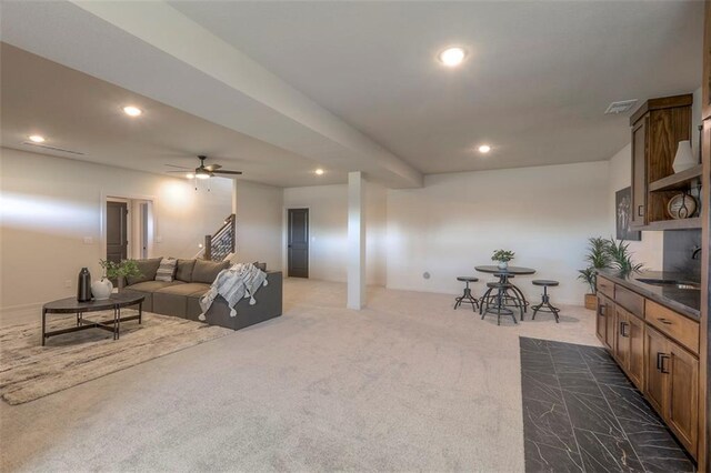 carpeted living room with sink