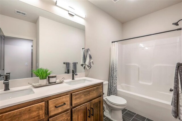 full bathroom featuring vanity, toilet, shower / bath combo with shower curtain, and tile patterned floors