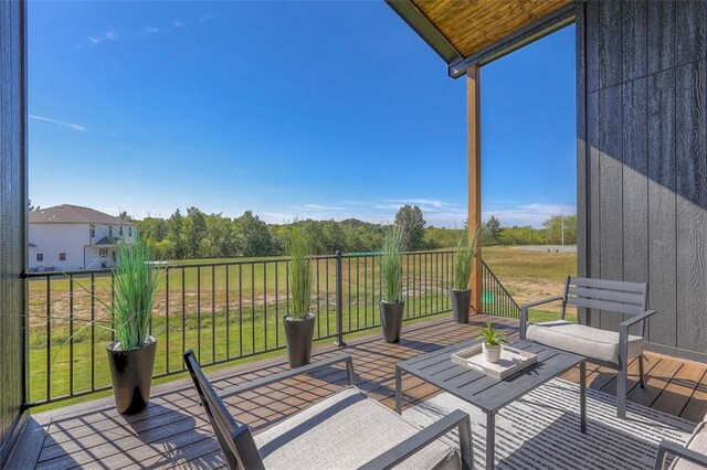 wooden terrace featuring a yard