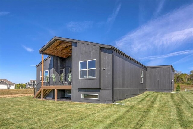 rear view of property featuring a lawn