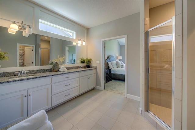 bathroom featuring vanity with extensive cabinet space, double sink, tile flooring, and walk in shower