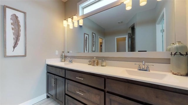 bathroom featuring large vanity and double sink