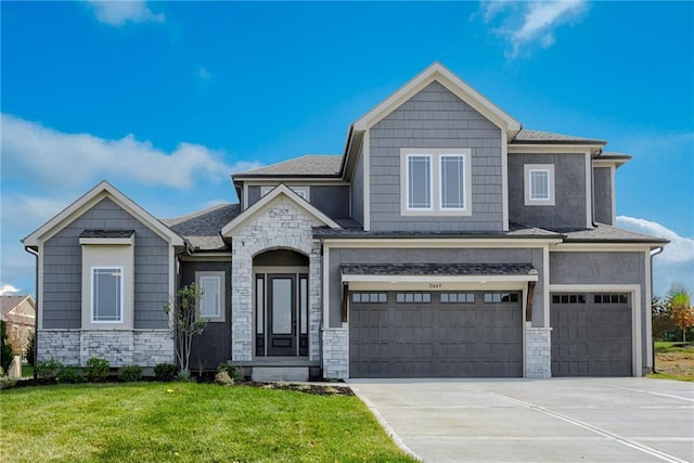 view of front of property with a front yard and a garage