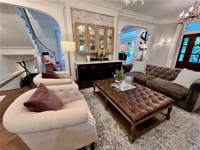 living room featuring crown molding and a chandelier