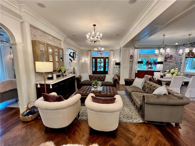 living room featuring an inviting chandelier, crown molding, plenty of natural light, and parquet floors