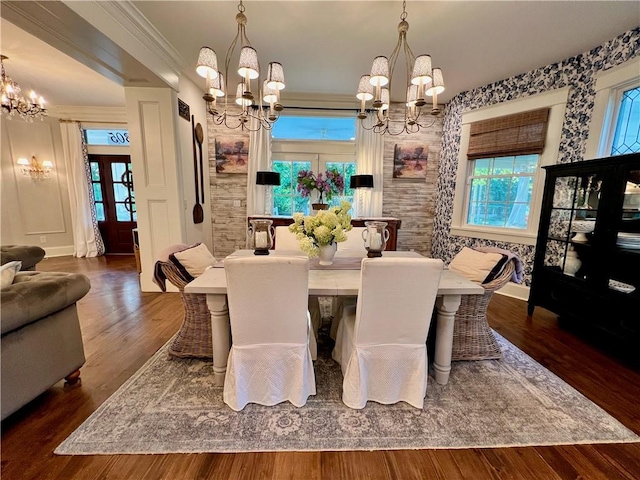 dining area featuring crown molding, dark hardwood / wood-style floors, and an inviting chandelier