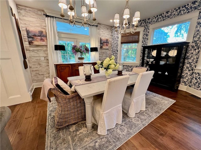 dining area featuring hardwood / wood-style floors and a chandelier