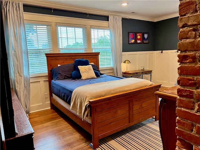 bedroom with crown molding and hardwood / wood-style flooring