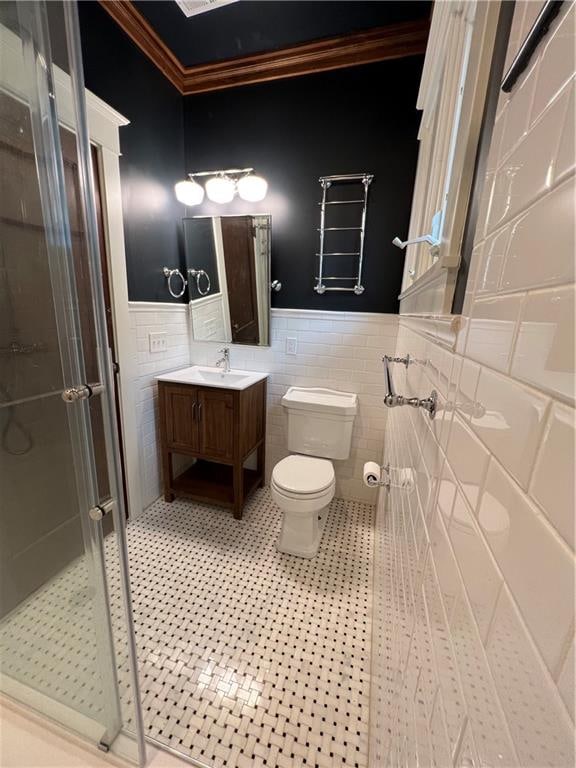 bathroom featuring vanity, tile walls, ornamental molding, tile flooring, and toilet