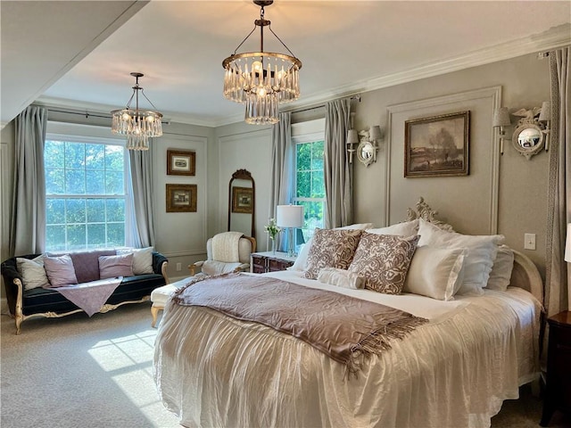 carpeted bedroom featuring a notable chandelier and crown molding