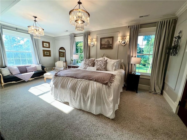 bedroom with carpet floors, a chandelier, and ornamental molding