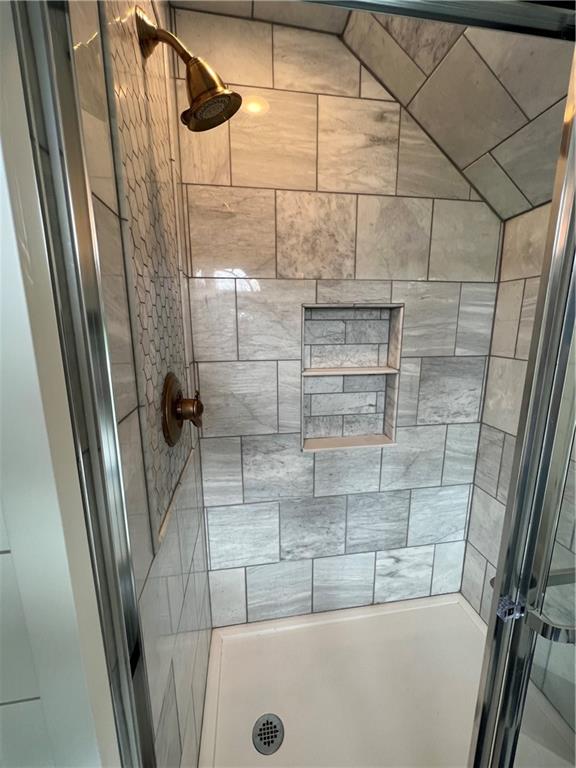 bathroom with tiled shower