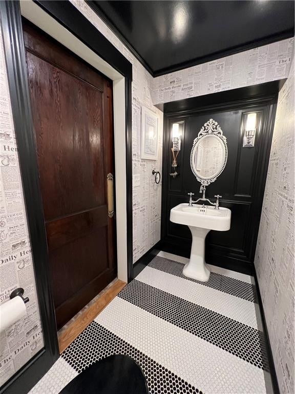 bathroom featuring tile flooring and crown molding