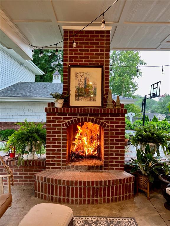 view of patio featuring an outdoor brick fireplace