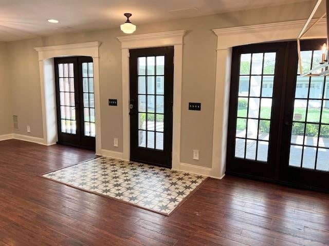 entrance foyer with french doors and dark hardwood / wood-style floors