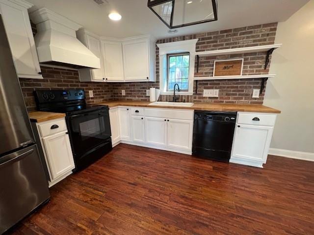 kitchen featuring butcher block countertops, black appliances, custom exhaust hood, sink, and dark hardwood / wood-style flooring