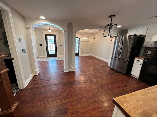 kitchen with decorative light fixtures, white cabinets, decorative columns, black range with electric cooktop, and dark hardwood / wood-style floors