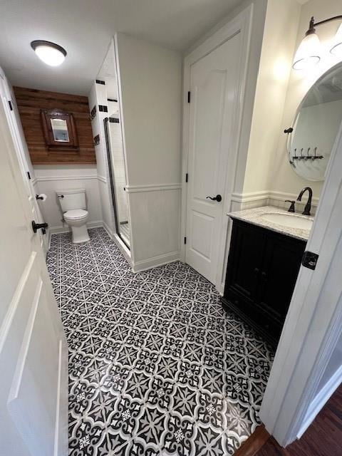 bathroom with tile flooring, vanity, and toilet