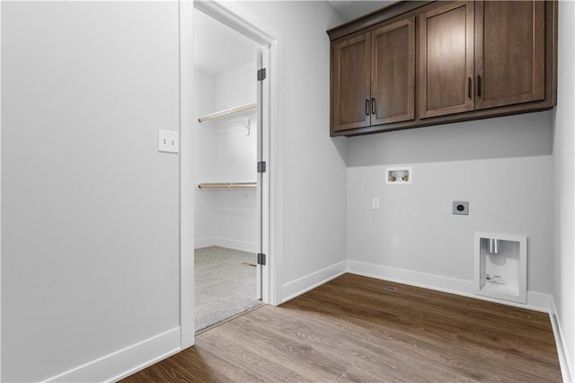 washroom with wood-type flooring, hookup for a washing machine, cabinets, and hookup for an electric dryer