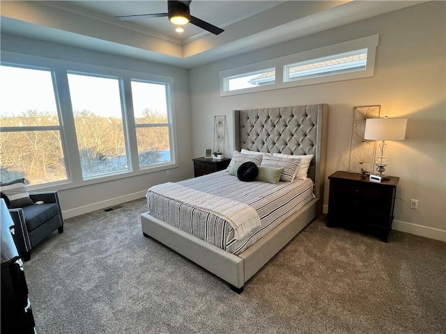 bedroom with carpet floors, a tray ceiling, ceiling fan, and ornamental molding