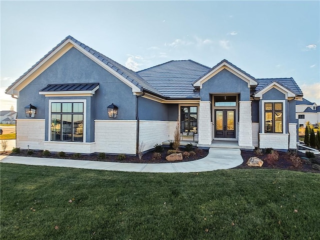 view of front of property featuring a front yard and french doors