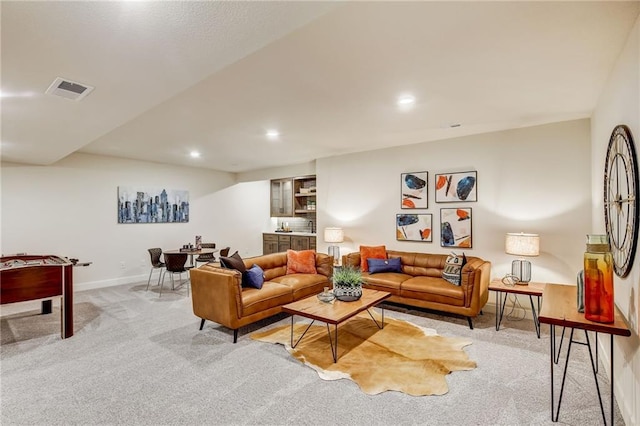 carpeted living area featuring recessed lighting, visible vents, and baseboards