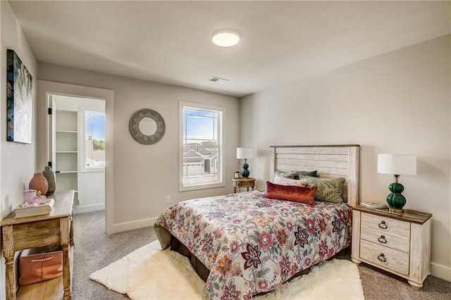 bedroom with light carpet, visible vents, and baseboards