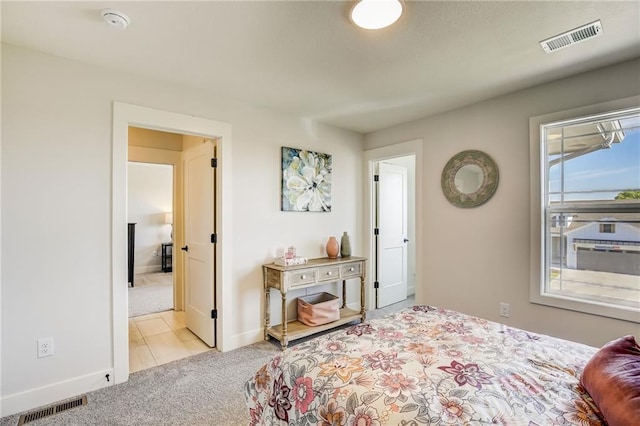 bedroom with carpet, visible vents, and baseboards