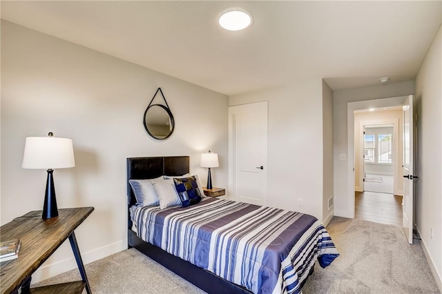 carpeted bedroom with baseboards