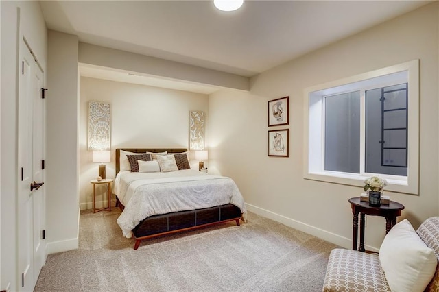 carpeted bedroom with baseboards