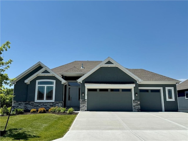 craftsman-style house with a garage and a front lawn