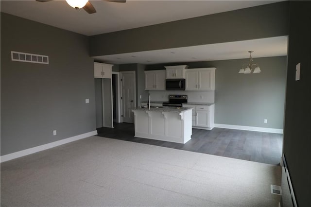 kitchen with white cabinetry, stainless steel electric range oven, sink, an island with sink, and decorative light fixtures