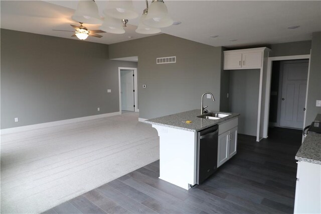 kitchen with white cabinetry, sink, dishwasher, and light stone counters