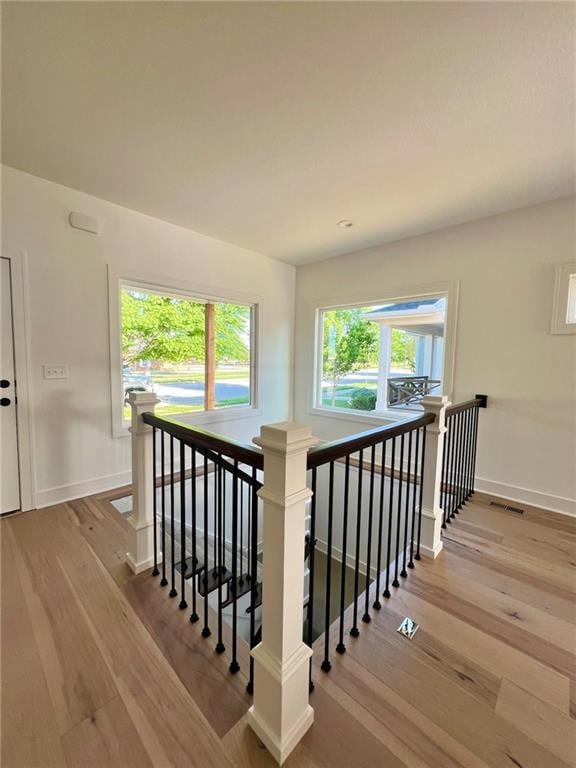 stairway with hardwood / wood-style flooring