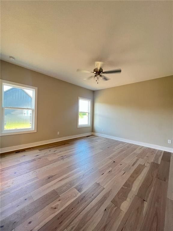 unfurnished room featuring ceiling fan and light hardwood / wood-style floors