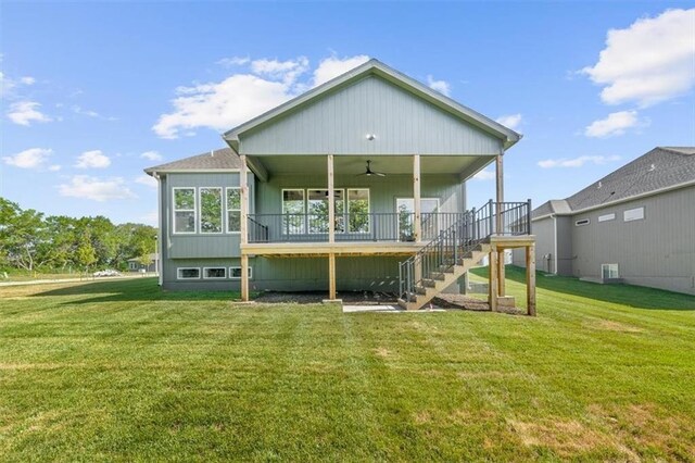 rear view of property with a lawn and ceiling fan