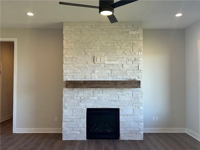 details featuring ceiling fan, a fireplace, and hardwood / wood-style floors