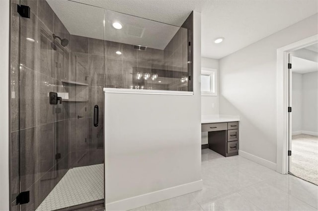 bathroom featuring vanity, tile patterned flooring, a textured ceiling, and a shower with door