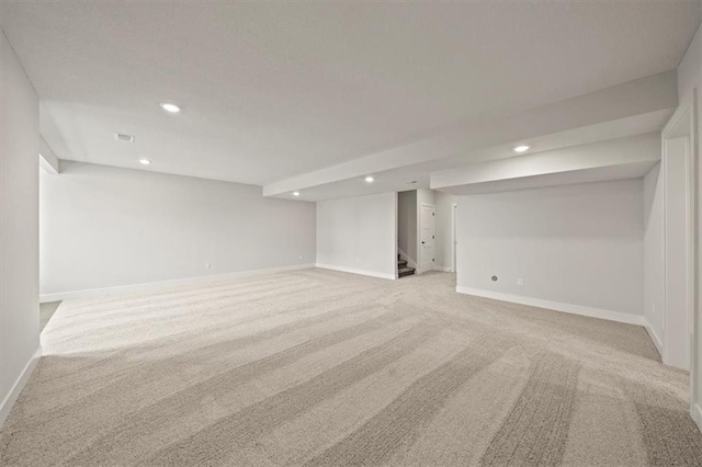 basement featuring light colored carpet