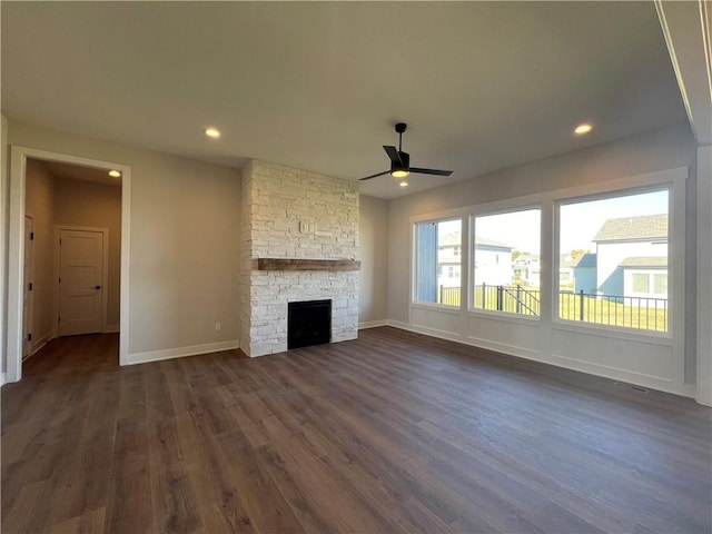 unfurnished living room with ceiling fan, dark hardwood / wood-style floors, and a fireplace