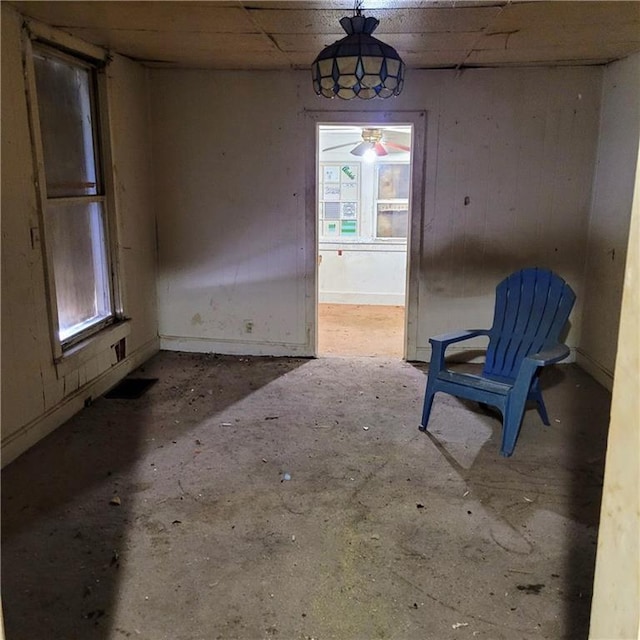 unfurnished dining area with concrete flooring and ceiling fan