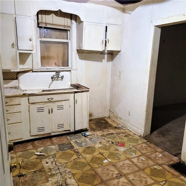 kitchen with white cabinetry and sink