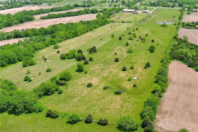 birds eye view of property with a rural view