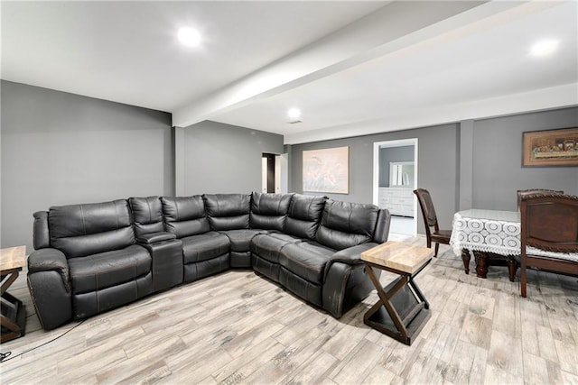 living room with beam ceiling and light wood-type flooring