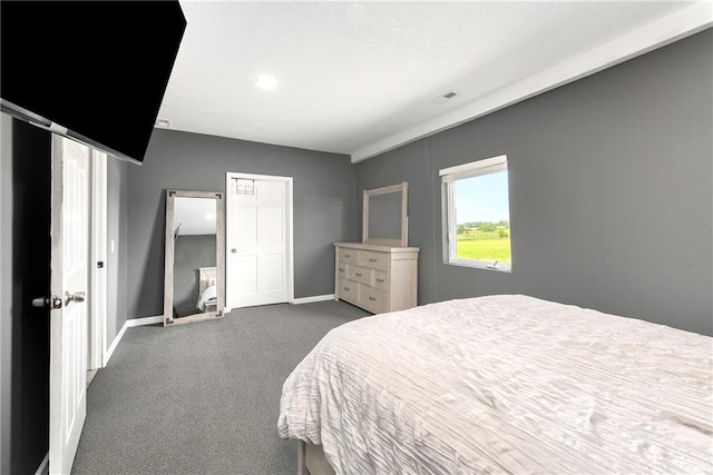 bedroom featuring dark colored carpet