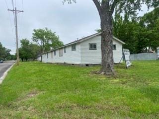 view of side of home featuring a lawn