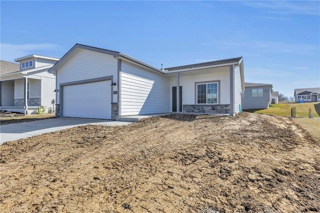 ranch-style house featuring concrete driveway and a garage